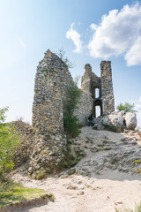 Castle ruin on the hill, blue sky and white clouds, path on the ground