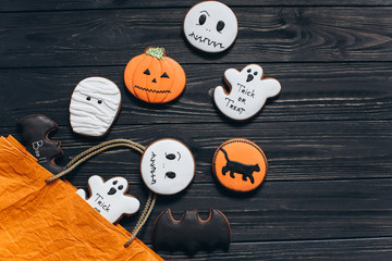 A package for Halloween with horror gingerbread on a black wooden background.