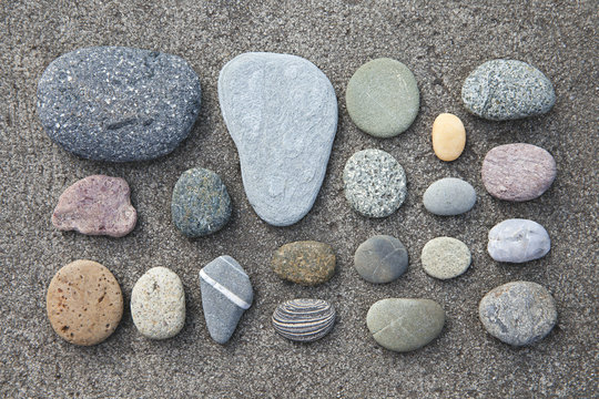 collection of rocks on a concrete background found on a beach