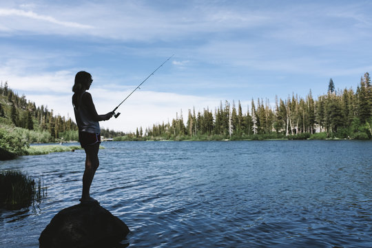 Young woman fishing in the lake