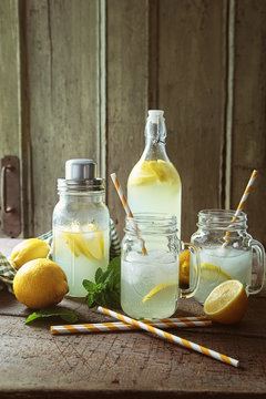 Cool summer lemonade in jars with straws