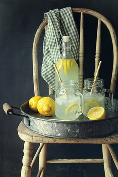 Fresh lemonade with ice and straws in tray