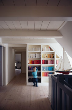 Boy in front of colorful bookcase