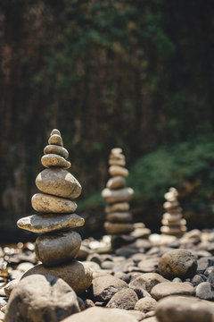 Cairns Stacked by a stream