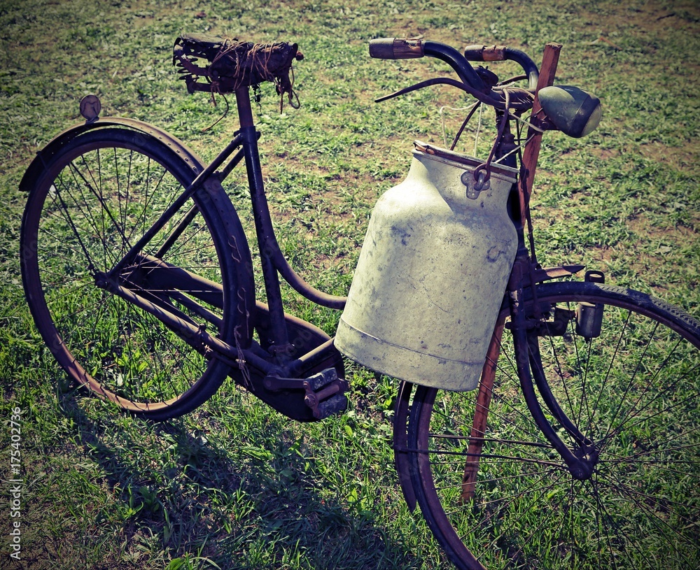 Poster ancient milking bike with milk bin and vintage effect