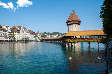 Lucerne, Switzerland - old wooden bridge and buildings on the lake embankment