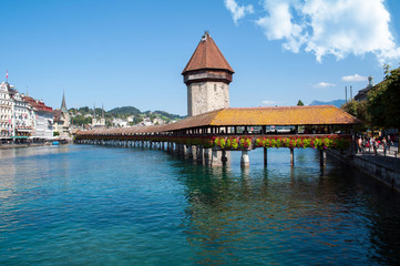 Lucerne, Switzerland - old wooden bridge over the river decorated with flowers