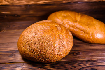 Different loafs of bread on wooden table