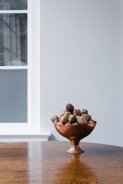 copper bowl with walnuts on an oak table