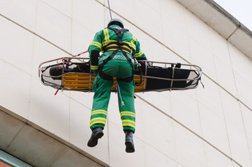 Paramedic is winched down a building on a rope with a patient during the launch of Northern Ireland...