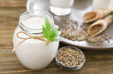 Jar with hemp milk on table