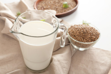 Jug with hemp milk on table