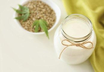 Jar with hemp milk on table