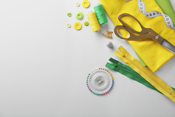 Composition with threads and sewing accessories on white background