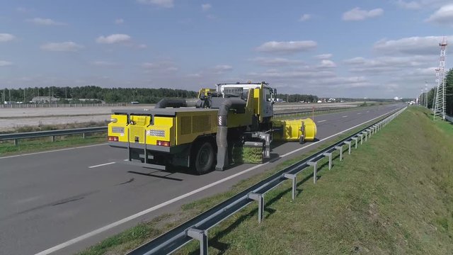 Road machinery for cleaning roads and highways from snow and dirt, big truck cleans the road, special machinery for airports, road truck