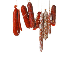 Delicious sausages hanging on white background