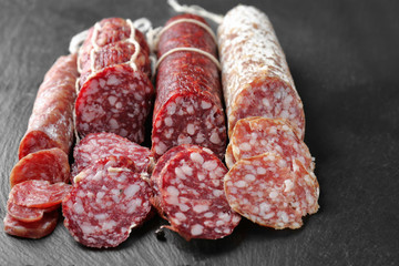 Delicious sliced sausages on table