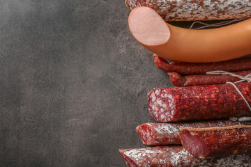 Delicious sausages on grey background