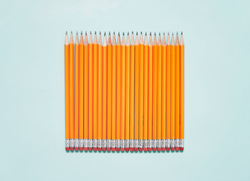 Row Of Pencils On Blue Background