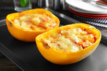 Halves of stuffed spaghetti squash on baking sheet