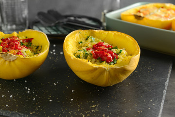 Halves of stuffed spaghetti squash on slate plate