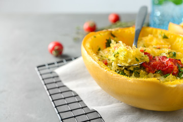 Half of stuffed spaghetti squash on table