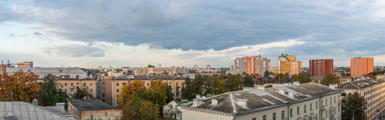Fototapeta na wymiar panoramic city view with old and modern buildings under the autumn cloudy sky
