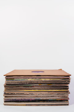 Stack of vinyl records on white
