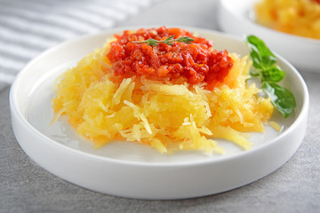 Plate with tasty spaghetti squash on table, close up