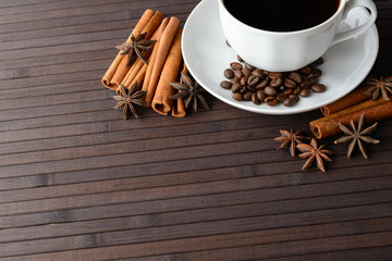 A hot Cup of coffee, cinnamon and star anise