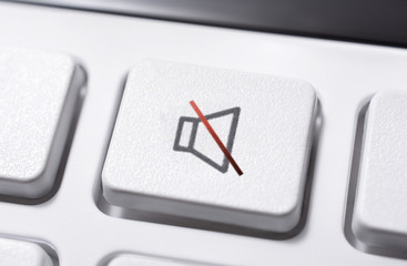 Macro Of A White Volume Mute Button Of A White Remote Control For A Hifi Stereo Audio System