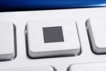 Macro Of A White Stop Button Of A White Remote Control For A Hifi Stereo Audio System