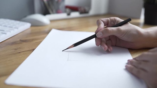 Painter draws by pencil, designer draws the draught, woman draws lines, architect begins to draw the project on paper