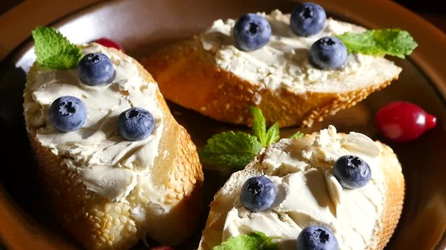 Bread with butter and  blueberries on a plate