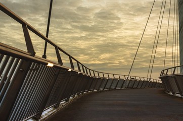 A cable-stayed bridge at sunset over the M20 Motoroway, Ashford, Kent, England