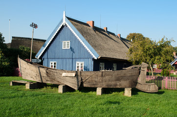Ancient fishing boat and ancient fisherman house in Nida. Lithuania