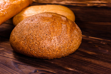 Different loafs of bread on wooden table