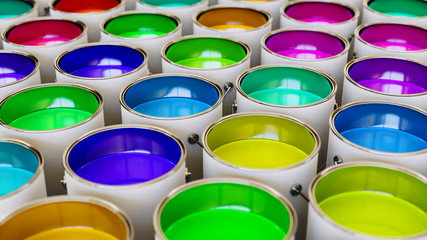 Uniformly packed grid of paint cans under neutral studio lighting.