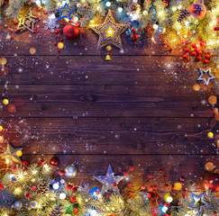 Christmas Background - Snowy Fir Branches And Lights On Dark Table
