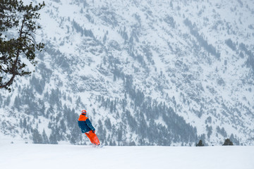 Skier on a snowboard in the mountains of Ordino in Anorra