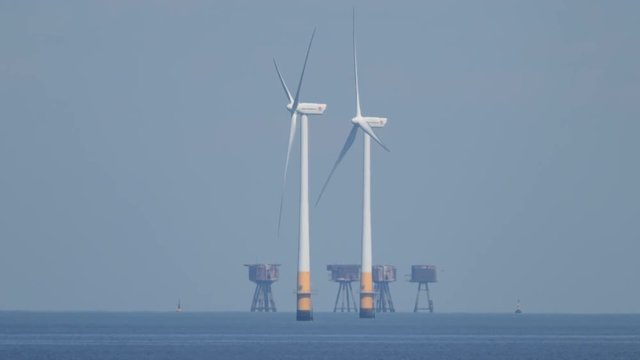offshore wind turbines producing clean renewable energy in the north sea, kent, uk