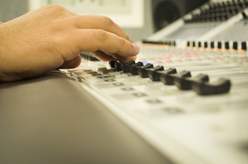 Fototapeta premium hand adjusting audio mixer