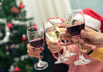 Closeup hands holding glass of wine, cocktail, champagne friend drinking celebration christmas home party interior