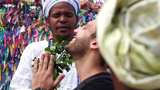 Candomble group blessing a tourist in Salvador, Bahia, Brazil