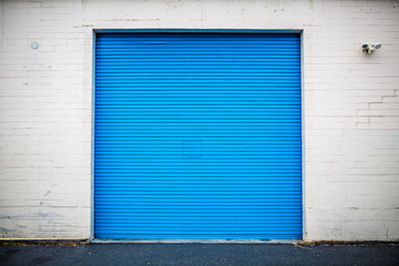 Blue Industrial Roll Up Door Inset in Brick Wall