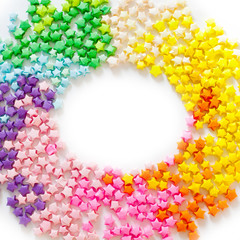 Colorful folded paper star or origami lucky star to use as frame.