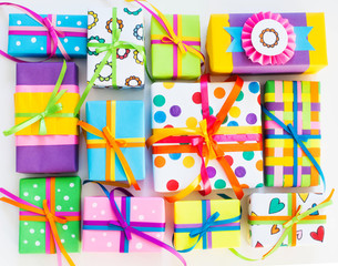 Colored gift boxes with colorful ribbons. White background. Gifts for Christmas or a birthday.