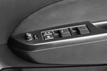 Close up of door control button on car.