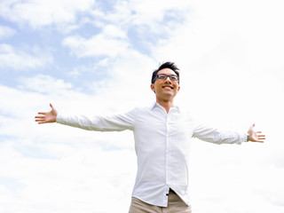 Young happy and successful businessman during his break in park