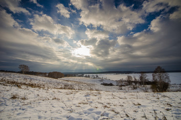Landscape of the steppe in white snow and a sky with clouds in winter